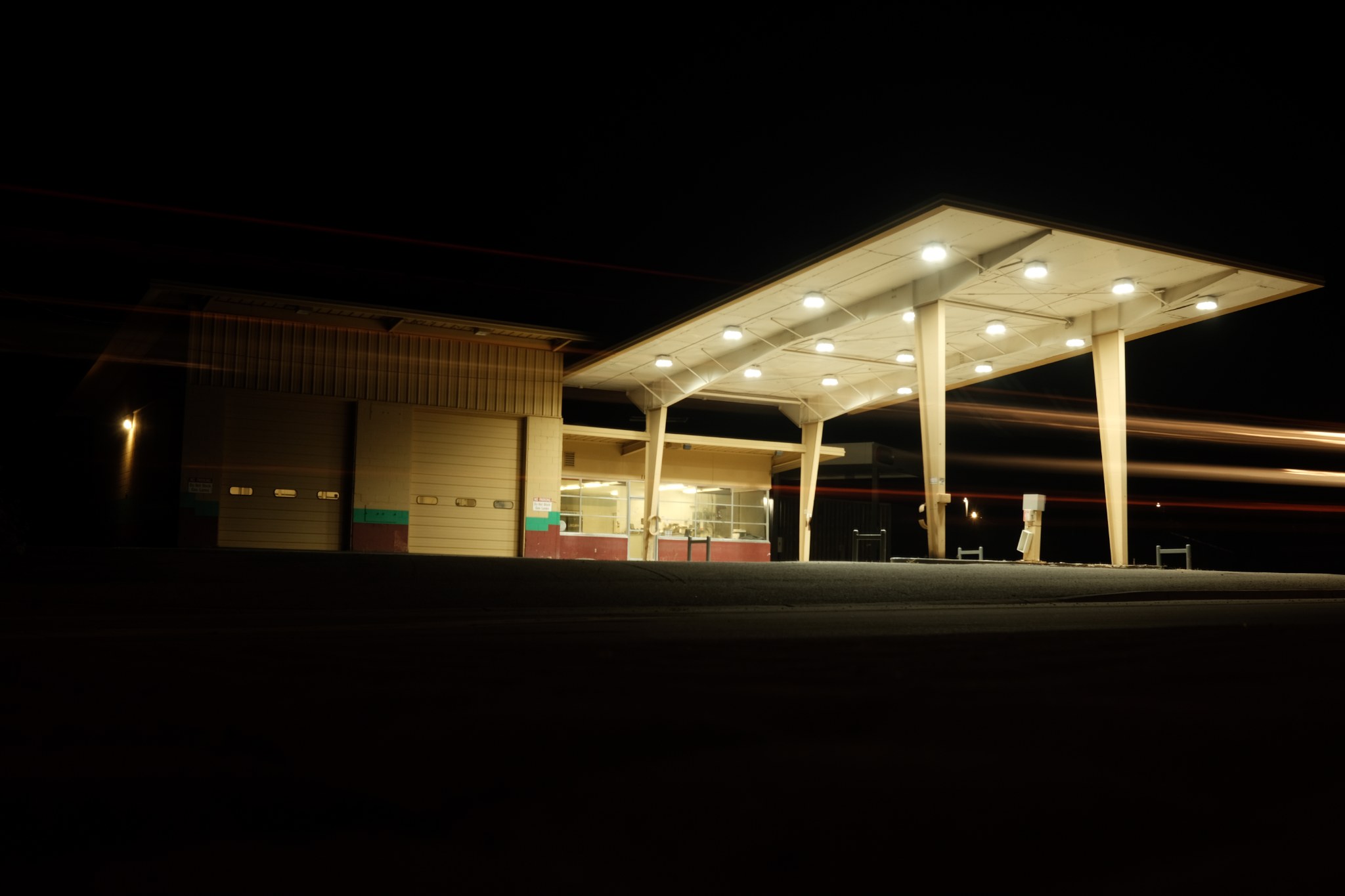 Deserted and rundown gas station in remote western Utah at night with shutter drag.
