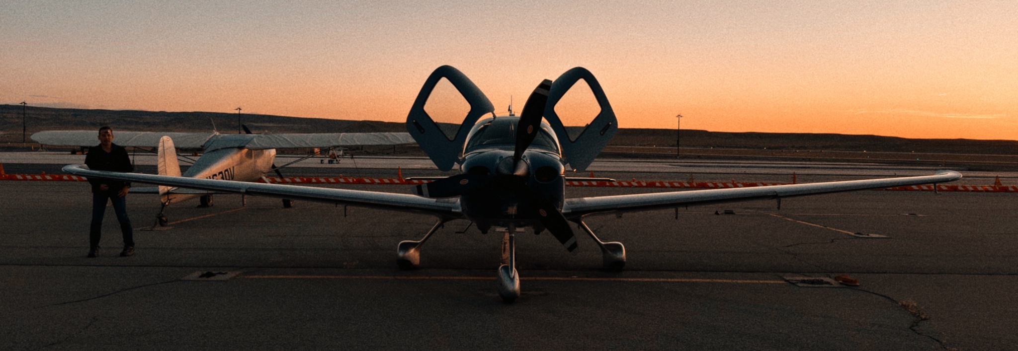 Pilot looks over his Cirrus S22T at the Canyonlands Field Airport outside Moab, Utah at sunset.